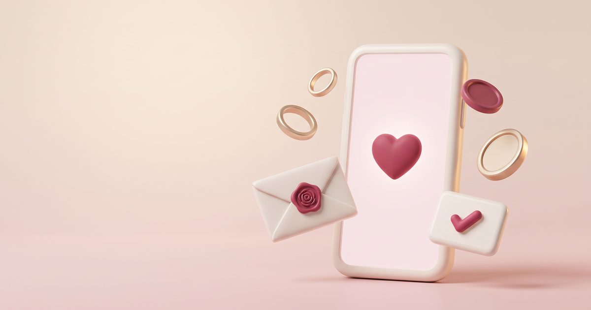 A cream phone with a rose heart on its screen, surrounded by rings, an envelope, a coin and a check mark