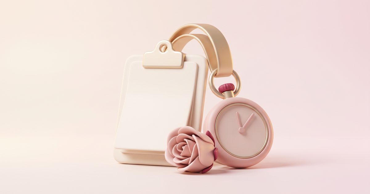 A cream clipboard with a blank page, a blush pocket watch and a rose bud, joined by a champagne gold ribbon