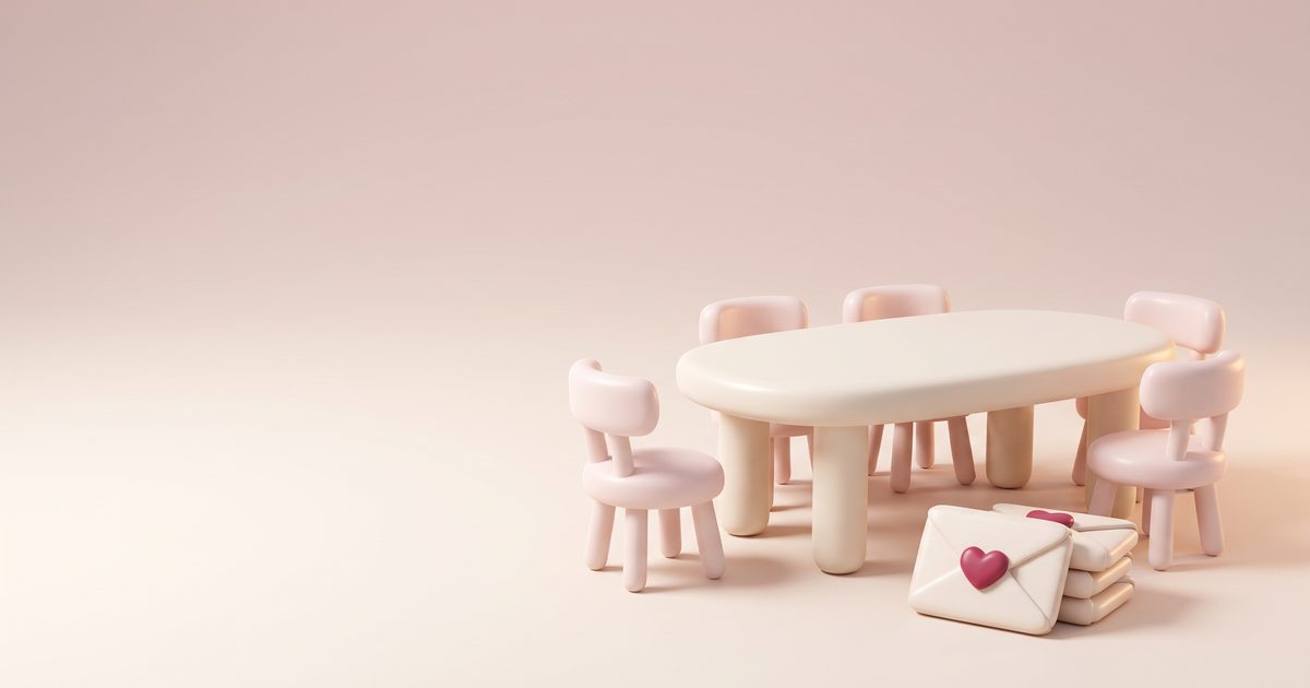 A round table with clay chairs, two pulled away, beside cream envelopes with rose seals