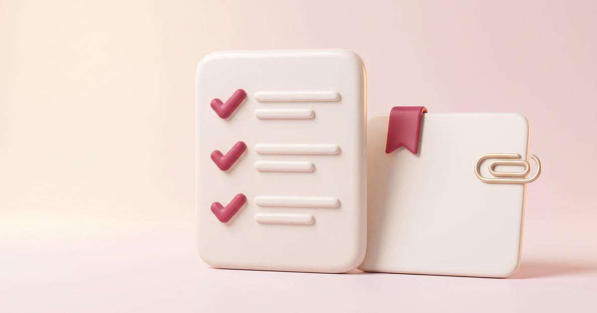 A cream checklist card with rose check marks beside a blank calendar page